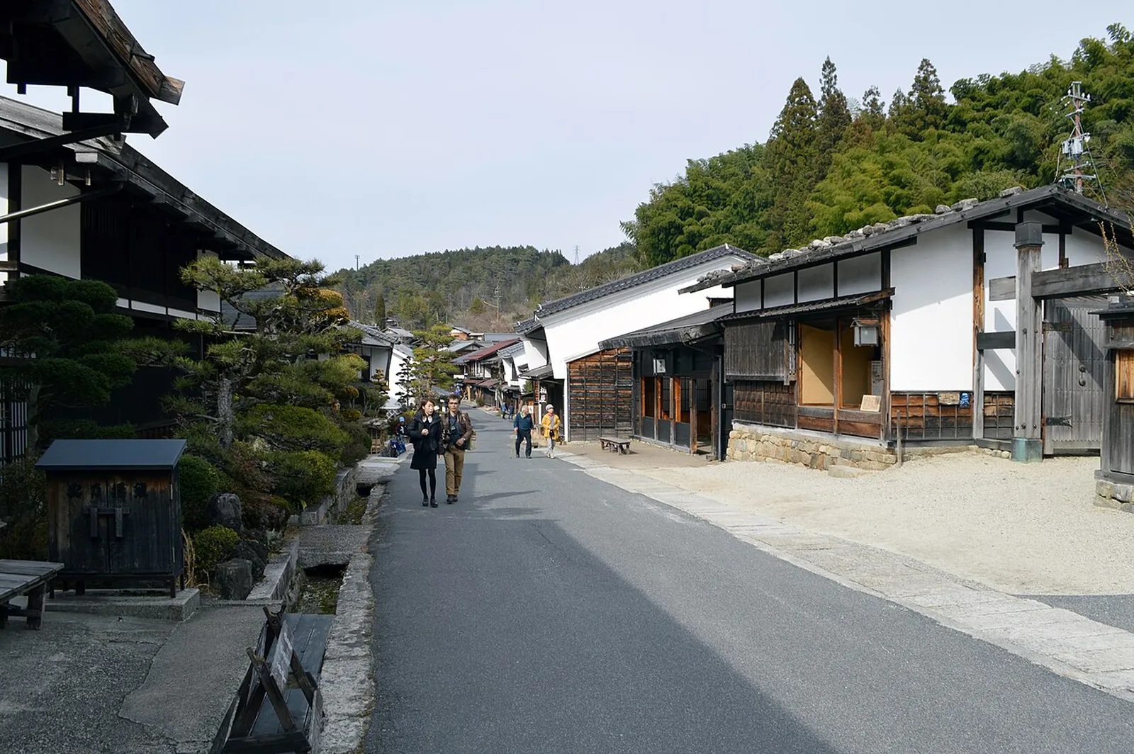 The Nakasendo running between dark wooden houses in the center of Tsumago-juku